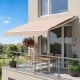 Retractable 8FT × 6.5FT aluminum patio sun awning in beige provides adjustable shade for outdoor spaces.