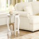 Round 2-tier end table in white with rubber wood legs, perfect for living room or bedroom storage.