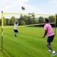 Portable outdoor volleyball net set in yellow, featuring adjustable poles and a robust net for easy setup and play.