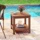 2-tier outdoor side table made of solid wood with storage shelf, ideal for patio use and featuring a slatted tabletop.