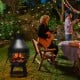 Patio wood burning chiminea fireplace with round mesh fire cage, sturdy iron construction, ideal for outdoor gatherings.