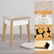 Cushioned stool with soft surface and solid wood legs, designed for use with a vanity table set for comfortable makeup.