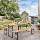 Folding wooden picnic table and benches set with natural wood grain, placed outdoors for versatile use and easy.