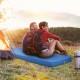 Self-inflating blue camping sleeping mattress with a couple relaxing outdoors, ideal for camping and travel.
