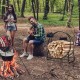 30-inch black powder-coated steel log hoop firewood storage rack, ideal for indoor and outdoor use by the fireplace.