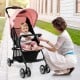 Toddler travel stroller in pink with adjustable backrest, 5-point harness, and canopy, ideal for airplane use.