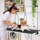 Foldable dog grooming table with height adjustable arms, non-slip surface, and storage tray for pet care and grooming.
