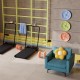 Modern accent chair in teal with a flower cushion, paired with a folding treadmill for home fitness and relaxation.