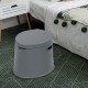 Portable 5L travel toilet in gray with paper holder, designed for indoor and outdoor use, supports up to 440 lbs.