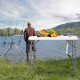 Folding cleaning sink table with sprayer, perfect for outdoor use, featuring a durable surface and integrated drain.