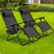 Two black folding lounge chairs with adjustable backs and removable headrests, perfect for outdoor relaxation in the.