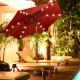 Heavy-duty square umbrella base stand with decorative bronze finish, securely holding umbrellas for outdoor use.