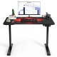 Electric standing gaming desk with height adjustable splice board, featuring a carbon fiber texture and noiseless motor.