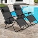 Two black folding lounge chairs with adjustable backs and cup holders, perfect for outdoor relaxation by the pool.