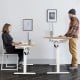 Electric adjustable sit to stand desk with a 55" x 28" surface, USB port, and smart control panel for height adjustment.