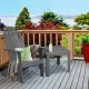 Gray acacia wood Adirondack chair with ergonomic design, perfect for outdoor relaxation on a patio or deck.