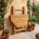 Folding octagonal acacia wood dining table for 4 with slatted tabletop, ideal for outdoor patios and gatherings.