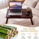 Adjustable bamboo laptop desk with tilting top and adjustable legs, perfect for studying, working, or dining at home.