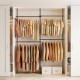 Adjustable black clothes rack features four hanging rods and ample space for shoes, perfect for versatile closet organization.