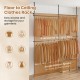 Adjustable floor-to-ceiling clothes rack in black with 4 hanging rods and ample bottom space for shoes and boxes.