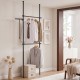 Adjustable black floor-to-ceiling clothes rack with two hanging rods, ideal for maximizing closet space and organization.