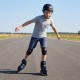 Child skating on adjustable blue roller skates with protective gear on a smooth outdoor surface.