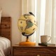 Mini rotating antique globe with a wooden base, featuring clear geographic details, perfect for education or decoration.