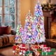 Three artificial Christmas trees with snow-flocked branches and multi-color LED lights, perfect for festive indoor.