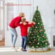 6 ft artificial PVC Christmas tree with solid metal stand, decorated for festive indoor holiday settings.