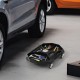 Automotive rolling tool creeper in black with 4 swivel casters, featuring 4 storage compartments for garage use.