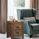 Wooden nightstand with two storage drawers in oak finish, featuring a spacious tabletop for decor and a compact design.
