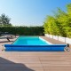 Aluminum pool cover reel set for in-ground pools, adjustable from 2.5 to 22 feet, featuring wheels for easy movement.