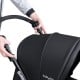 Close-up of the black foldable double baby stroller with adjustable push handle, designed for two babies.
