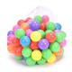 Colorful plastic balls in a mesh bag, perfect for playhouses and imaginative outdoor activities.