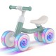 Baby balance bike in green with adjustable seat and handlebars, featuring glowing wheels for indoor and outdoor fun.