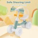 Baby balance bike in green with adjustable seat and handlebars, featuring lighting wheels for indoor and outdoor fun.