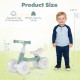 Green baby balance bike with an adjustable seat and handlebars, showcasing dimensions and suitable for ages 12-36.