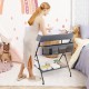 Baby storage folding diaper changing table in gray with three side compartments for easy access to accessories.