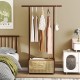 Bamboo clothes rack with hanging rod and rattan storage basket on wheels, ideal for stylish organization in any room.