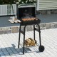 Barrel charcoal grill in black with foldable side table, thermostat, and storage shelf, perfect for backyard cooking.