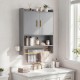 Wall-mounted grey bathroom cabinet with gold handles, featuring closed storage, open shelves, and towel bars for.
