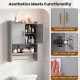 Wall-mounted grey bathroom cabinet with golden handles, soft-close hinges, and towel bars for organized storage.