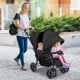 Double baby stroller in black with adjustable seats and safety features, perfect for two children on the go.