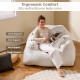Bean bag chair in beige with plush velvet cover, featuring ergonomic back and arm support for ultimate relaxation.