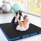 Thick black bi-fold gymnastics mat with carrying handles, ideal for yoga and stretching, featuring a waterproof cover.