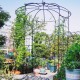 Birdcage shape gazebo made of galvanized metal, ideal for climbing plants and wedding decoration in a garden setting.