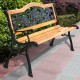 Cast iron outdoor bench with rose pattern backrest and solid wood seat, perfect for patio seating.