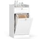Tilt-out laundry hamper cabinet in white with a drawer and removable laundry bag for organized bathroom storage.