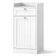 Tilt-out laundry hamper cabinet in white with drawer, removable laundry bag, and raised edges for bathroom organization.