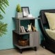 Modern wooden nightstand with asymmetrical design, featuring storage space and stable legs, ideal for small living.